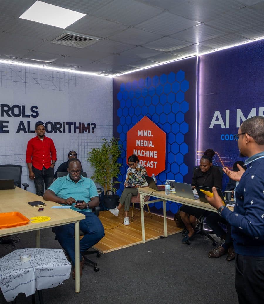 Participants working at laptops at the AI Media Lab's workstations during a session.